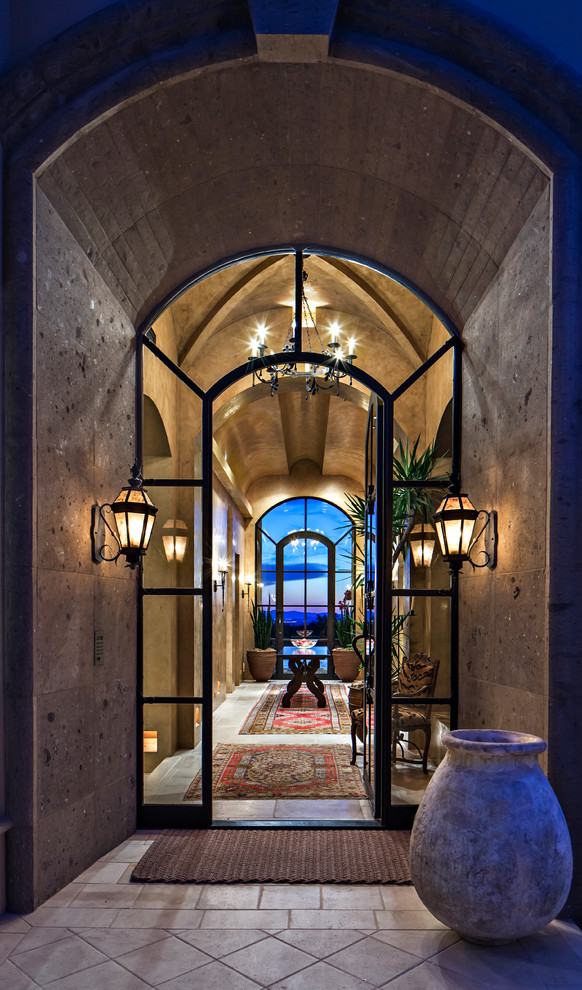 Design ideas for a large mediterranean entry hall in Phoenix with a single front door and a glass front door.