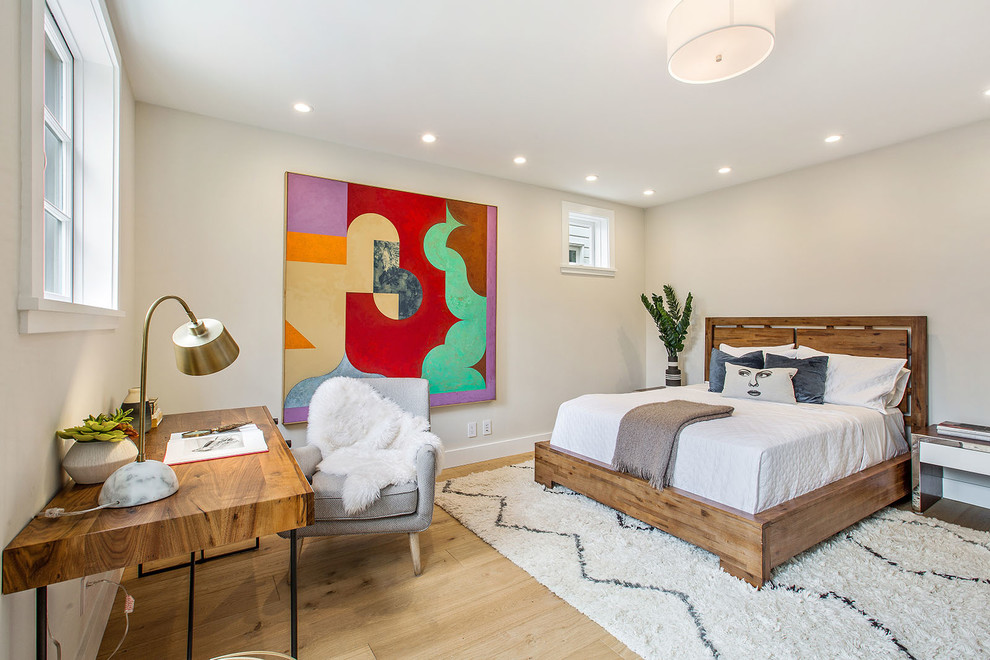 Transitional bedroom in San Francisco with beige walls, light hardwood floors and beige floor.
