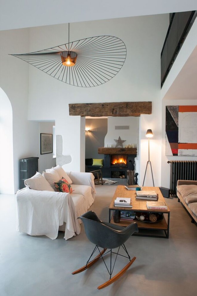 Idée de décoration pour un grand salon urbain ouvert avec un mur blanc, sol en béton ciré, une cheminée standard, un manteau de cheminée en bois et un sol gris.