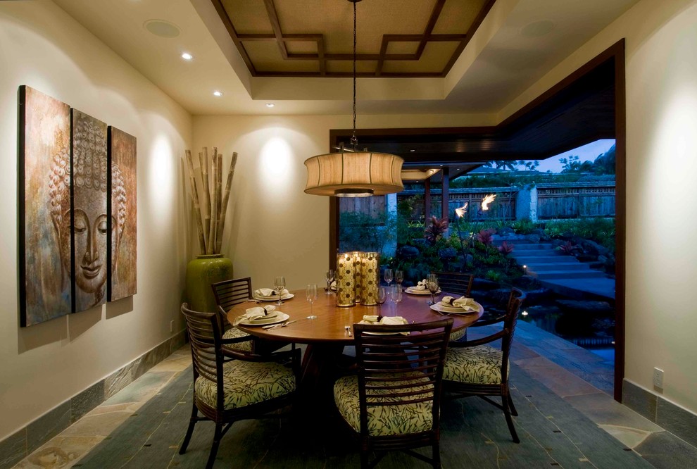 Mid-sized tropical separate dining room in Hawaii with beige walls, slate floors and no fireplace.