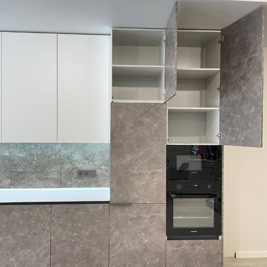 Expansive contemporary grey and white single-wall kitchen/diner in Moscow with a submerged sink, flat-panel cabinets, grey cabinets, granite worktops, brown splashback, porcelain splashback, black appliances, medium hardwood flooring, no island, grey floors, white worktops and a drop ceiling.