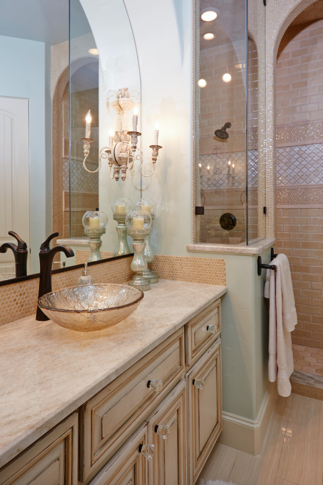 Inspiration for a mediterranean master bathroom in Dallas with raised-panel cabinets, a freestanding tub, an open shower, a one-piece toilet, beige tile, limestone, green walls, limestone floors, an undermount sink, onyx benchtops, beige floor, an open shower and yellow benchtops.