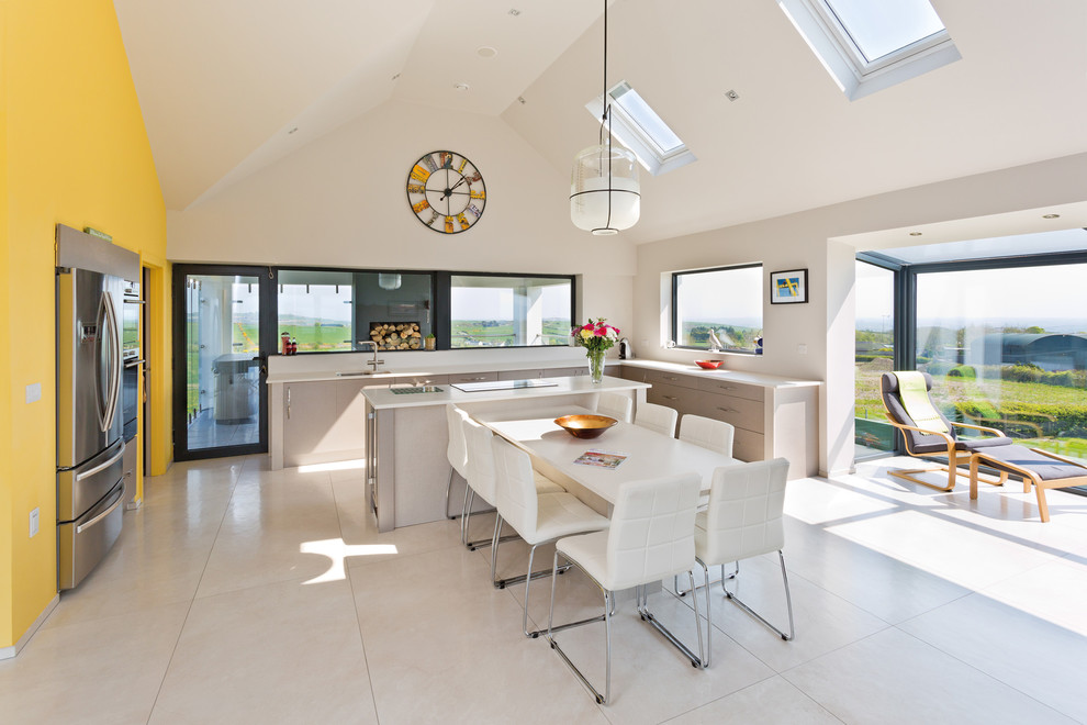 Large contemporary l-shaped open plan kitchen in Belfast with a drop-in sink, flat-panel cabinets, porcelain floors and with island.