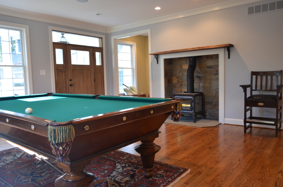 Large transitional open concept family room in Philadelphia with a game room, blue walls, medium hardwood floors, no tv, a wood stove and brown floor.