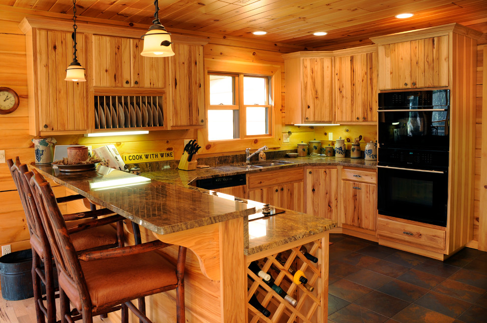 Eat-in kitchen - mid-sized rustic l-shaped ceramic tile eat-in kitchen idea with an undermount sink, flat-panel cabinets, light wood cabinets, black appliances and a peninsula