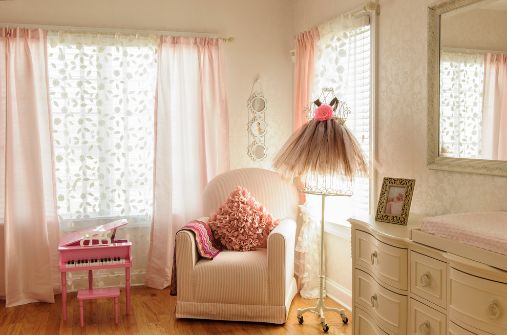 Inspiration for a mid-sized traditional nursery for girls in New York with beige walls and medium hardwood floors.