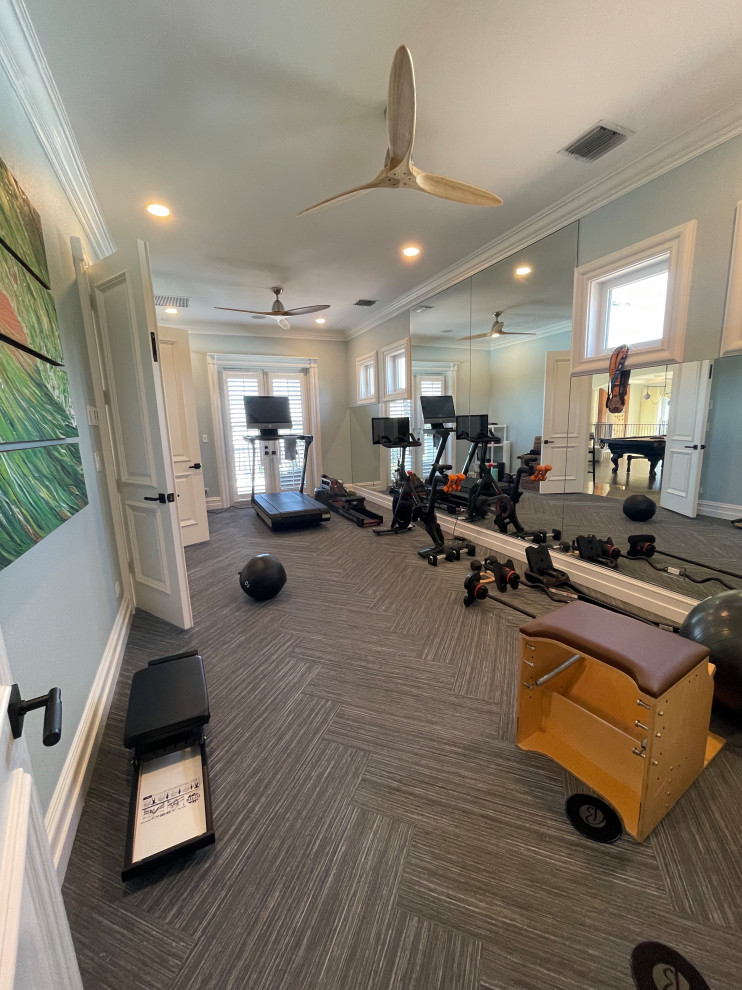 This is an example of a mid-sized transitional home gym in Miami with blue walls, vinyl floors and blue floor.