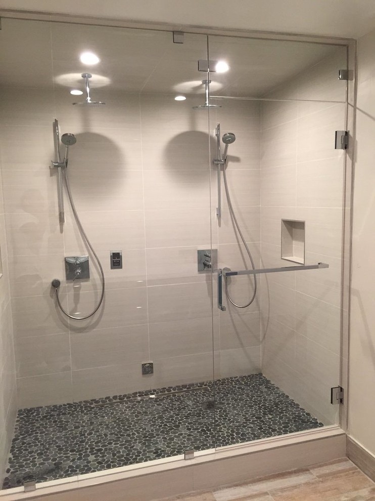 Inspiration for a mid-sized arts and crafts master bathroom in San Francisco with white tile, flat-panel cabinets, grey cabinets, an alcove shower, a one-piece toilet, pebble tile, beige walls, light hardwood floors, an undermount sink and solid surface benchtops.