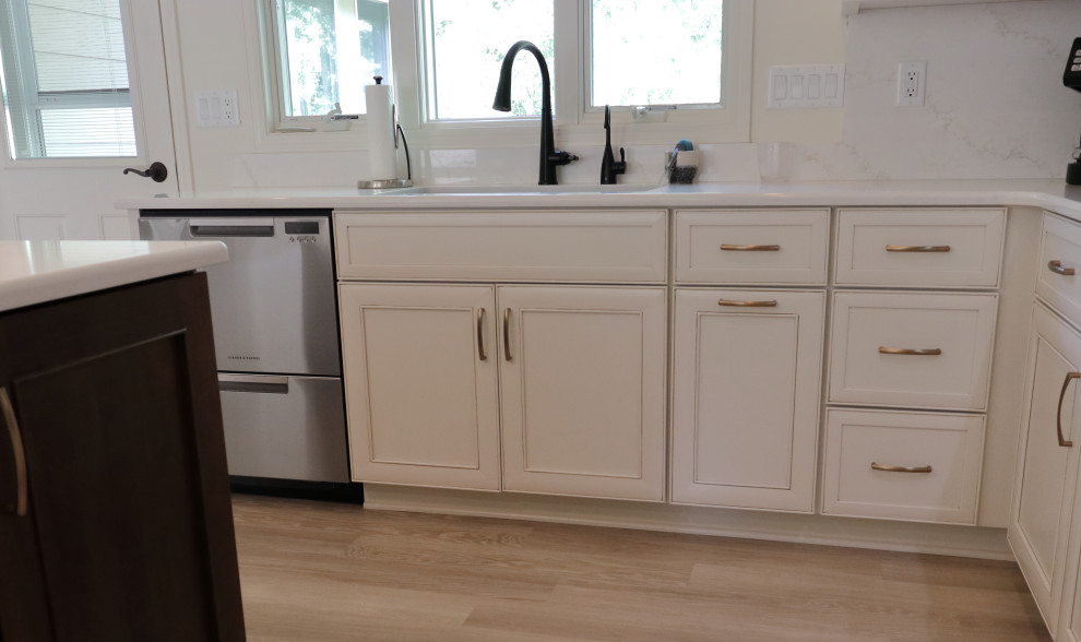 Example of a large transitional l-shaped kitchen design with an undermount sink, recessed-panel cabinets, quartz countertops, white backsplash, quartz backsplash, stainless steel appliances and white countertops