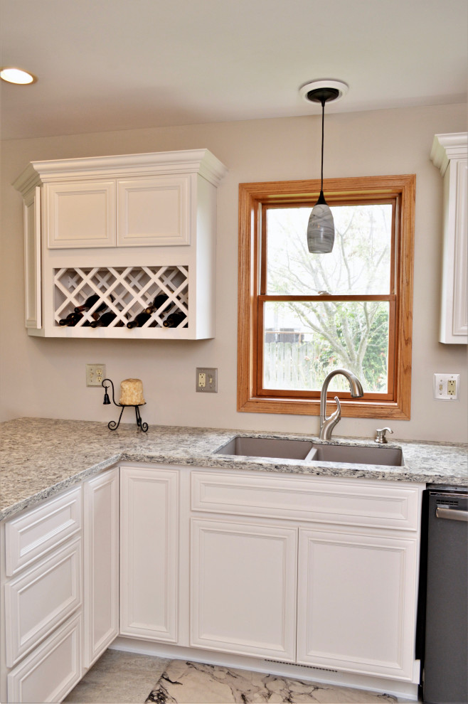 Mid-sized transitional l-shaped eat-in kitchen photo in Chicago with an undermount sink, recessed-panel cabinets, white cabinets, quartzite countertops, stainless steel appliances, a peninsula and gray countertops