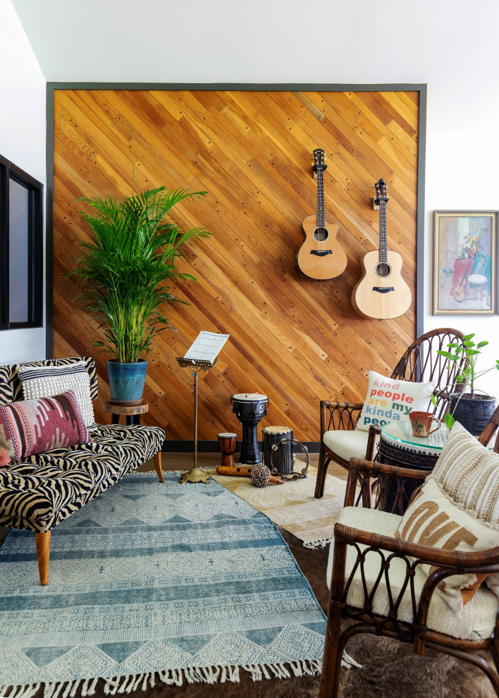 Photo of a midcentury family room in Houston with white walls, brown floor and wood walls.