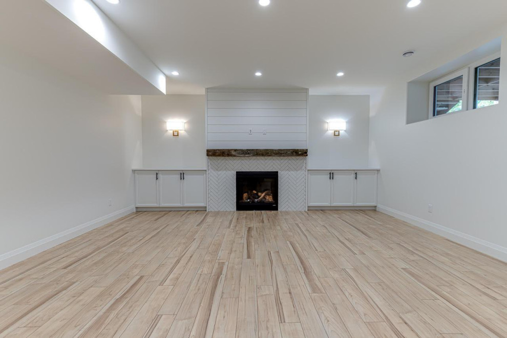Example of a mid-sized cottage enclosed light wood floor and beige floor family room design in Other with a standard fireplace, a tile fireplace, white walls and a wall-mounted tv