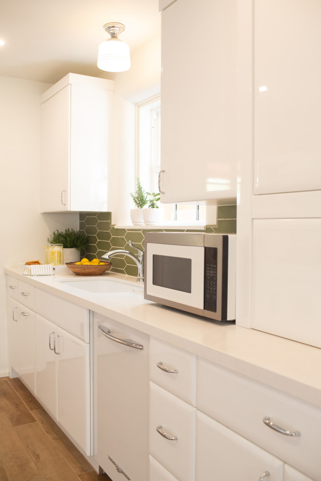 Small arts and crafts galley eat-in kitchen in Phoenix with a double-bowl sink, flat-panel cabinets, white cabinets, quartz benchtops, green splashback, ceramic splashback, white appliances, ceramic floors, no island, brown floor, white benchtop and exposed beam.