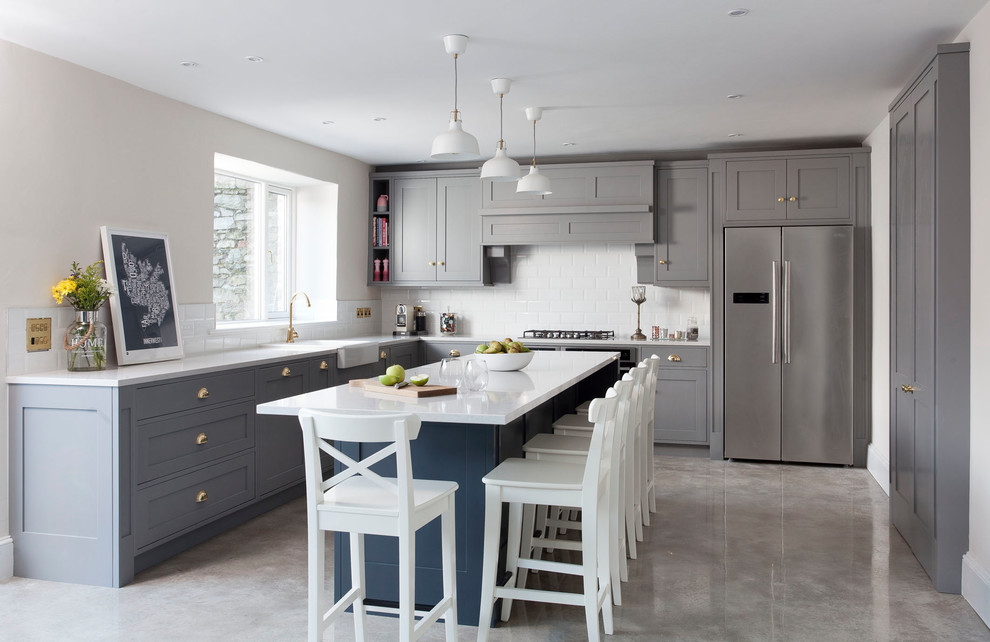 Design ideas for a mid-sized transitional l-shaped eat-in kitchen in Other with shaker cabinets, grey cabinets, quartzite benchtops, white splashback, ceramic splashback, concrete floors, with island, grey floor and white benchtop.