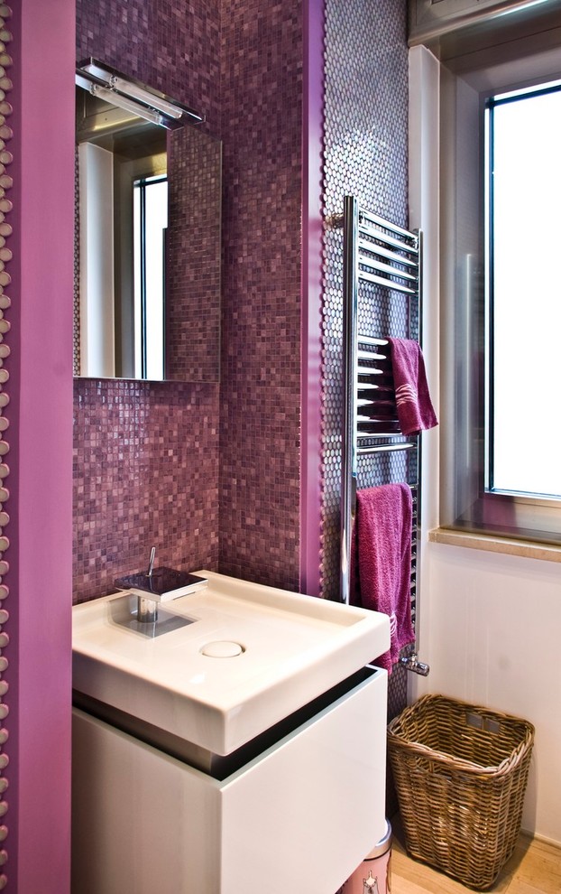 Photo of a small contemporary bathroom in Naples with flat-panel cabinets, light wood cabinets, a corner shower, a two-piece toilet, pink tile, porcelain tile, white walls, light hardwood floors, a drop-in sink and engineered quartz benchtops.