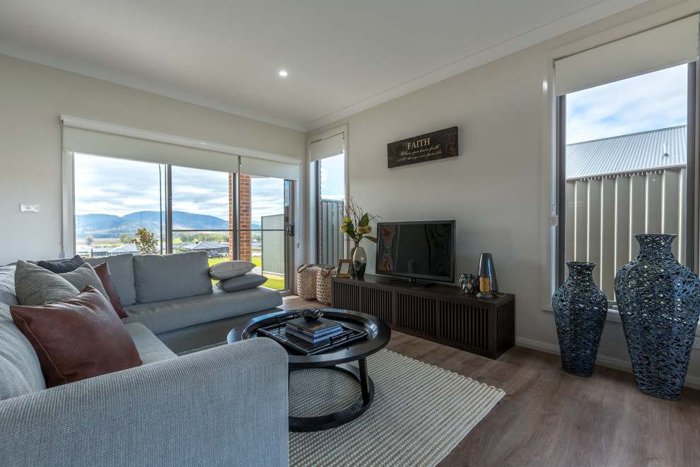 Design ideas for a large contemporary open concept living room with white walls, carpet, no fireplace, a freestanding tv and brown floor.