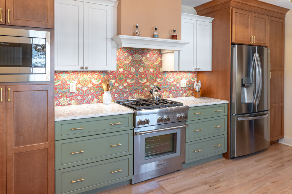 This is an example of a medium sized eclectic galley enclosed kitchen in Milwaukee with a submerged sink, shaker cabinets, green cabinets, engineered stone countertops, multi-coloured splashback, stainless steel appliances, medium hardwood flooring, no island, brown floors and multicoloured worktops.