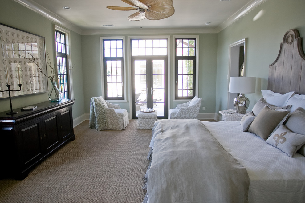 Inspiration for a beach style bedroom in Charleston with green walls.