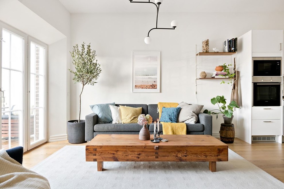 Design ideas for a scandinavian formal open concept living room in Other with white walls, medium hardwood floors and beige floor.