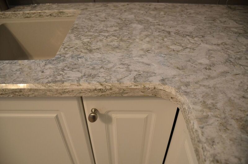 Inspiration for a mid-sized transitional u-shaped vinyl floor open concept kitchen remodel in Toronto with an undermount sink, raised-panel cabinets, white cabinets, quartzite countertops, gray backsplash, glass tile backsplash, white appliances and a peninsula