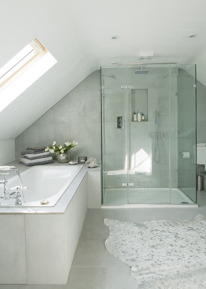 Contemporary bathroom in Oxfordshire with a drop-in tub, gray tile and white walls.