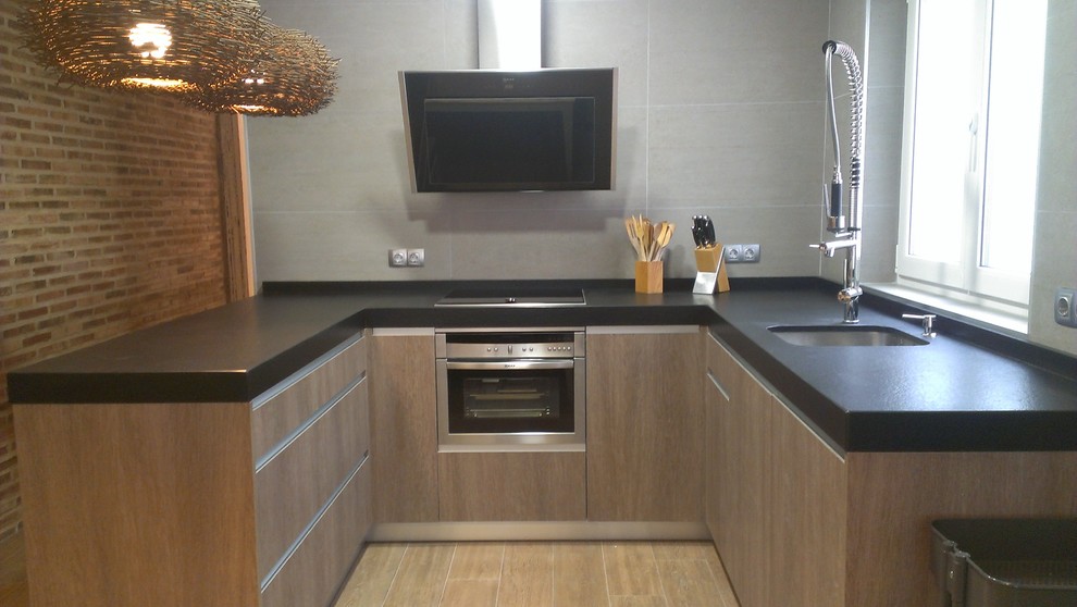 This is an example of a mid-sized transitional u-shaped separate kitchen in Other.