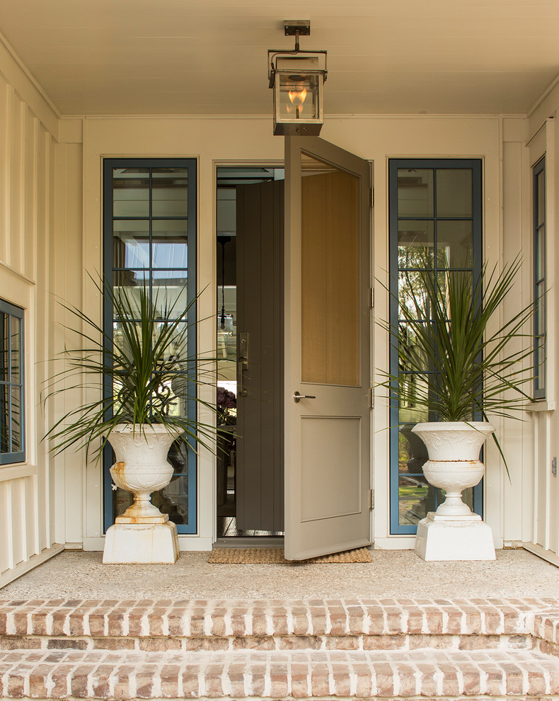 Design ideas for a beach style front door in Charlotte with a single front door and a gray front door.