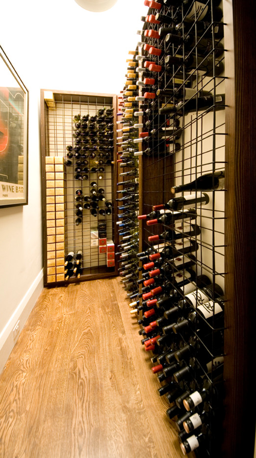 Inspiration for a modern wine cellar in Melbourne with medium hardwood floors and storage racks.