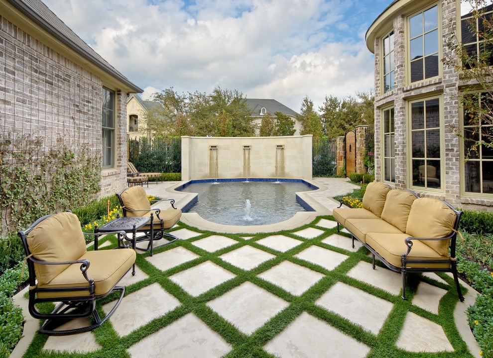 Photo of a traditional courtyard patio in Dallas with a water feature and no cover.