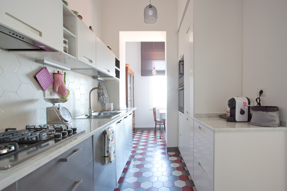 Design ideas for a large eclectic galley kitchen in Naples with a double-bowl sink, flat-panel cabinets, ceramic floors, no island and multi-coloured floor.