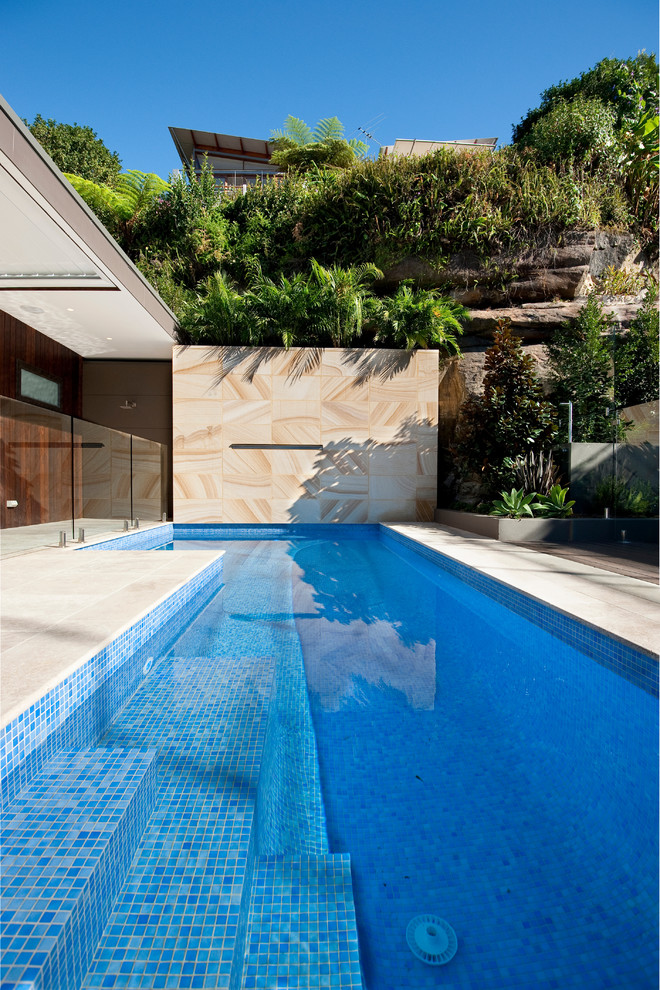 Design ideas for a contemporary backyard custom-shaped pool in Sydney.