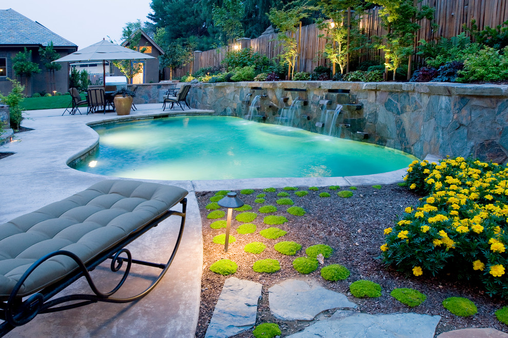 Inspiration for a mid-sized traditional backyard custom-shaped pool in Portland with a water feature.