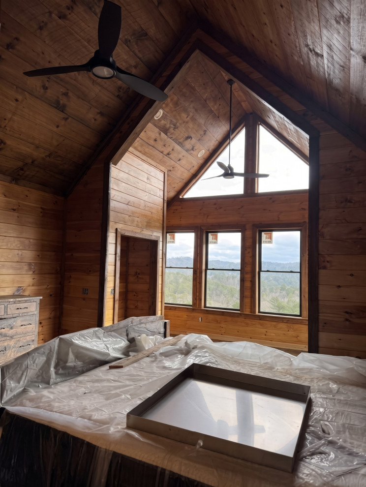 Rustic Primary Bedroom with Vaulted Wood Ceiling and Windows