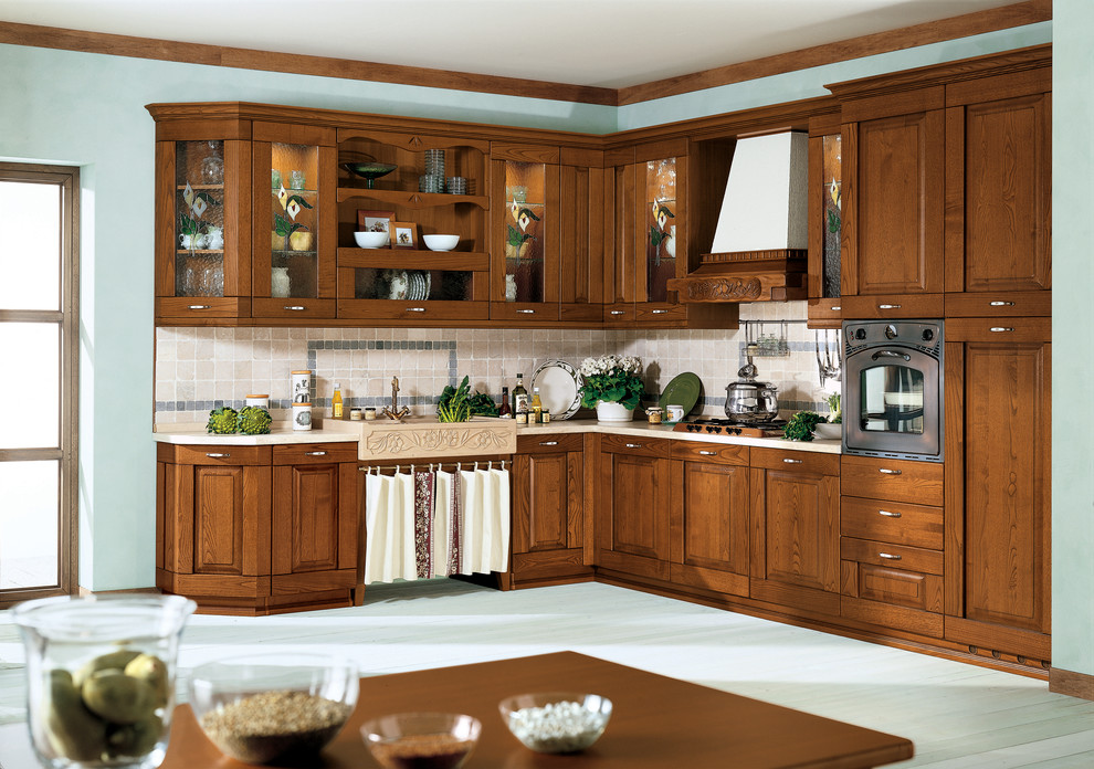 Inspiration for a mid-sized traditional l-shaped eat-in kitchen in San Diego with a double-bowl sink, flat-panel cabinets, medium wood cabinets, quartzite benchtops, beige splashback, ceramic splashback, panelled appliances, light hardwood floors and no island.