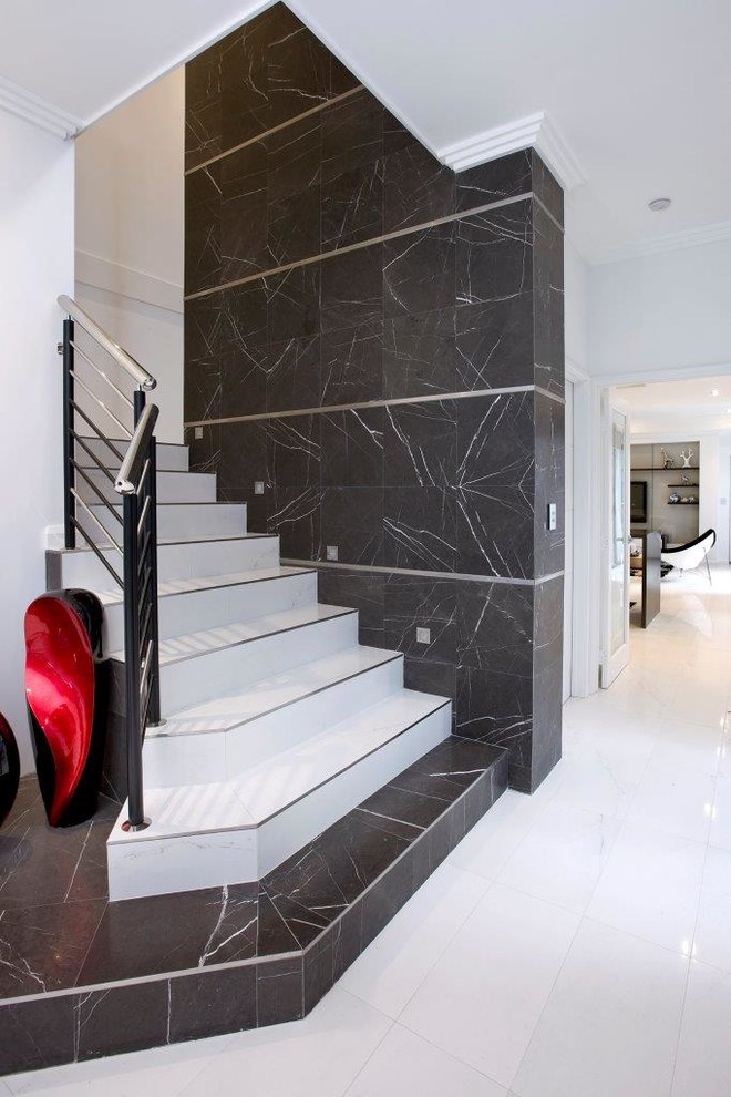Inspiration for a modern tile u-shaped staircase in Perth with tile risers, metal railing and decorative wall panelling.