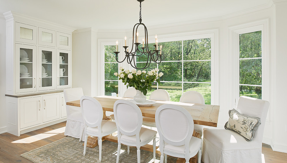 Inspiration for a large traditional dining room in Grand Rapids with white walls, medium hardwood floors and no fireplace.