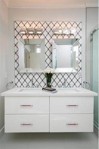 Design ideas for a mid-sized contemporary master bathroom in San Francisco with flat-panel cabinets, white cabinets, an alcove shower, a two-piece toilet, black and white tile, ceramic tile, white walls, porcelain floors, an undermount sink, solid surface benchtops, white floor, a sliding shower screen and white benchtops.