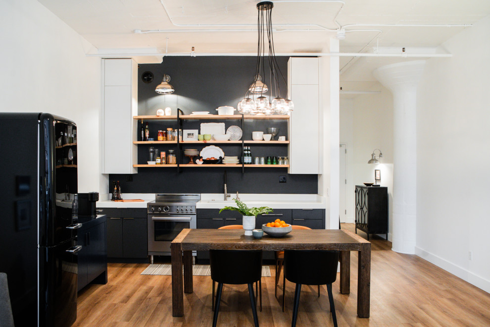 Small contemporary single-wall eat-in kitchen in Portland with an undermount sink, open cabinets, black cabinets, quartzite benchtops, black splashback, stainless steel appliances, vinyl floors, no island, brown floor and white benchtop.