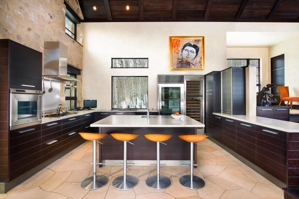 Photo of a large contemporary u-shaped kitchen in Denver with an undermount sink, flat-panel cabinets, dark wood cabinets, stainless steel appliances, with island and metallic splashback.