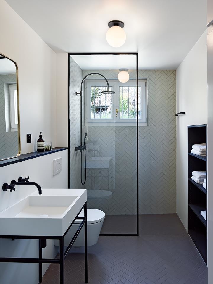Design ideas for a large contemporary master bathroom in Miami with open cabinets, black cabinets, a curbless shower, a wall-mount toilet, black and white tile, porcelain tile, white walls, porcelain floors, a console sink and an open shower.