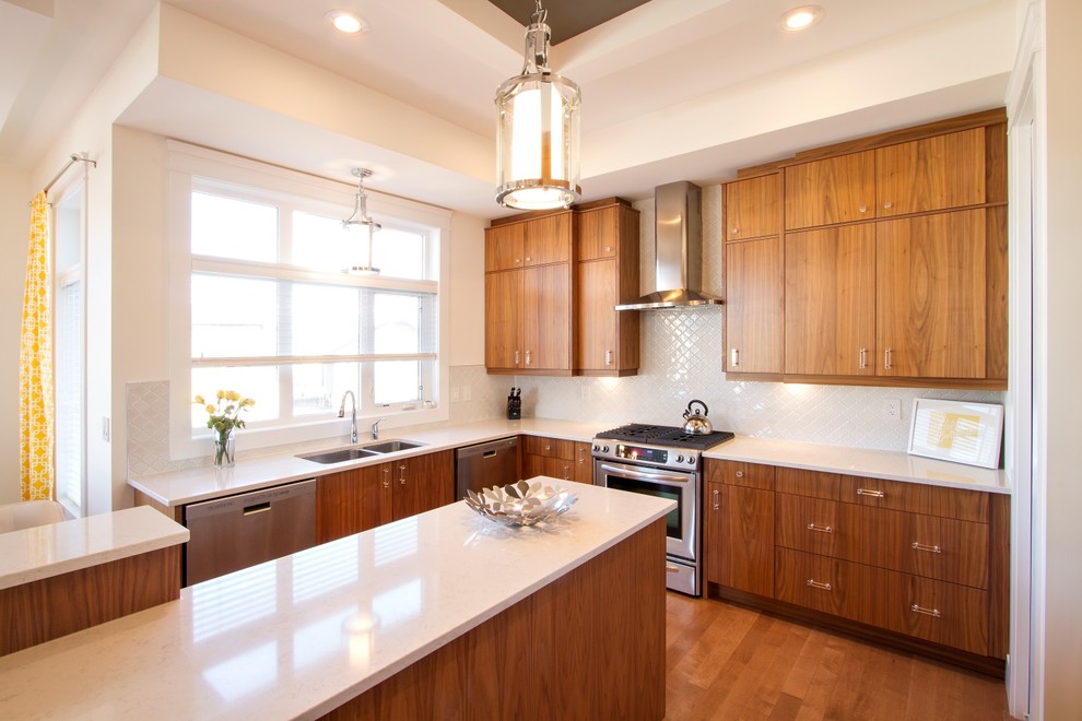 Large minimalist l-shaped medium tone wood floor eat-in kitchen photo with an undermount sink, flat-panel cabinets, medium tone wood cabinets, quartz countertops, white backsplash, ceramic backsplash, stainless steel appliances and an island