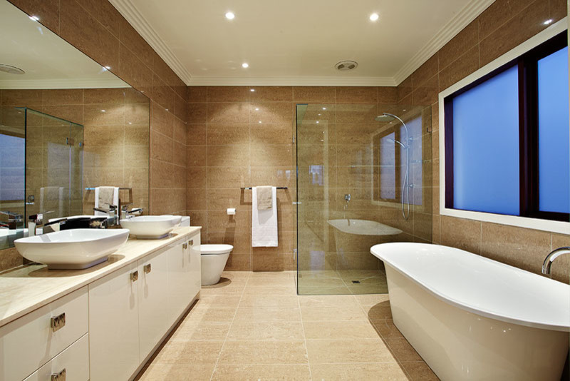 Photo of a large contemporary master bathroom in Melbourne with flat-panel cabinets, white cabinets, a freestanding tub, an open shower, a two-piece toilet, brown tile, ceramic tile, brown walls, ceramic floors and an integrated sink.