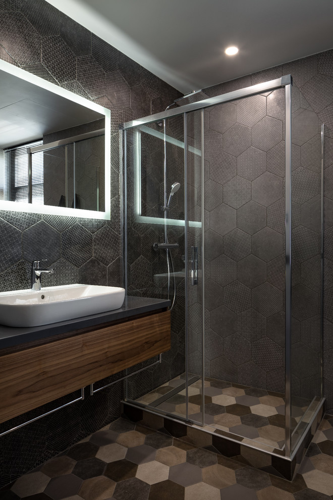 This is an example of a large contemporary 3/4 bathroom in Moscow with flat-panel cabinets, dark wood cabinets, a corner shower, black tile, ceramic tile, ceramic floors, a drop-in sink, solid surface benchtops, multi-coloured floor, a sliding shower screen and grey benchtops.