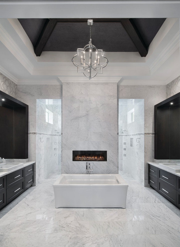 Transitional master bathroom in Miami with shaker cabinets, dark wood cabinets, a freestanding tub, grey walls, marble floors, a drop-in sink, marble benchtops, an open shower, gray tile, white tile and an open shower.