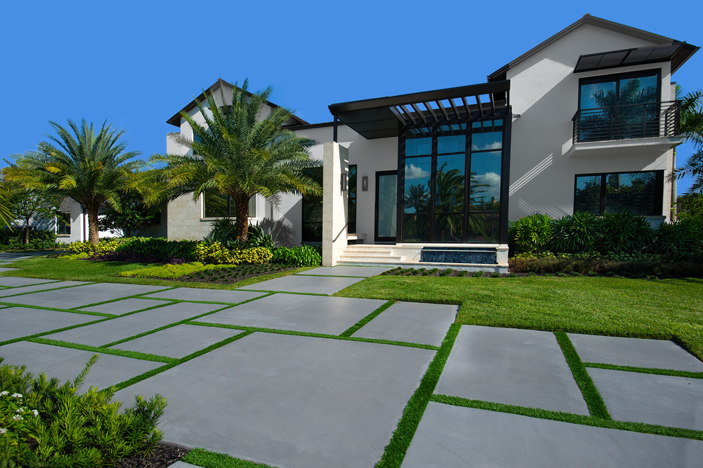 This is an example of a large contemporary two-storey white exterior in Miami with mixed siding and a gable roof.