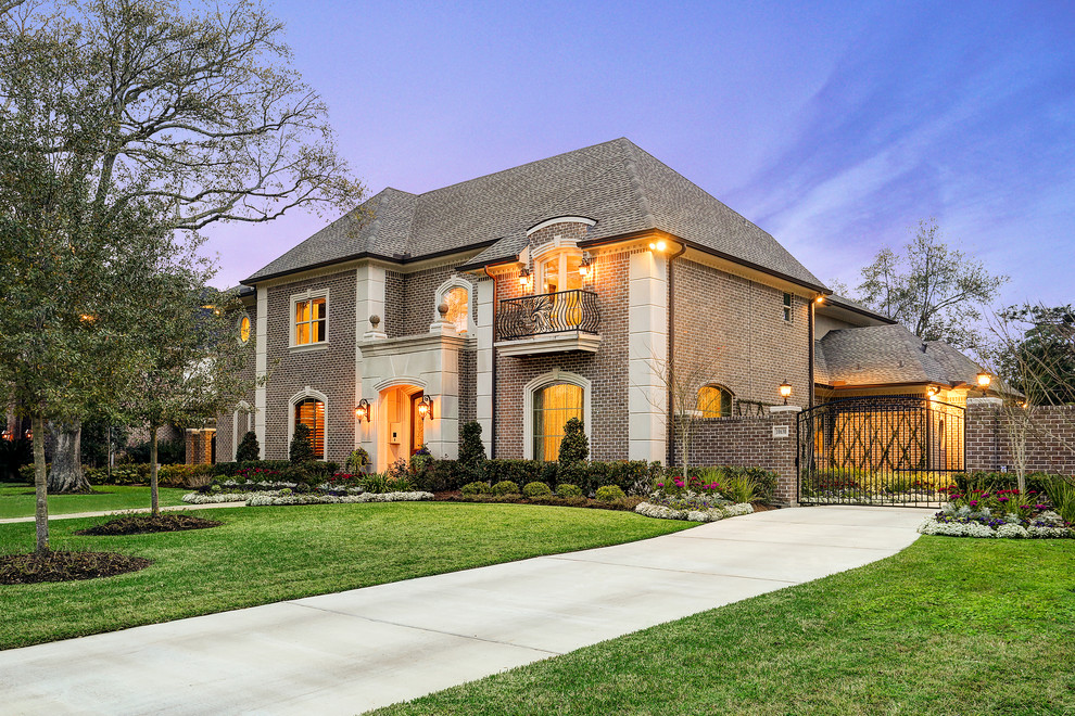 Design ideas for a large traditional two-storey brick red exterior in Houston.