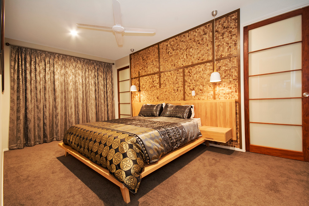 Inspiration for a large asian master bedroom in Sunshine Coast with green walls and carpet.