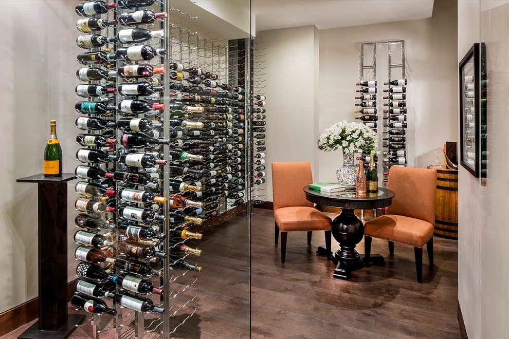Photo of a mid-sized contemporary wine cellar in Orange County with dark hardwood floors and storage racks.