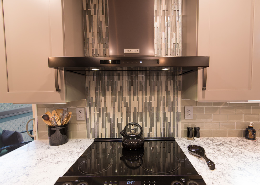 Eat-in kitchen - mid-sized transitional l-shaped brown floor eat-in kitchen idea in Baltimore with a single-bowl sink, shaker cabinets, gray cabinets, quartz countertops, gray backsplash, subway tile backsplash, stainless steel appliances, an island and white countertops