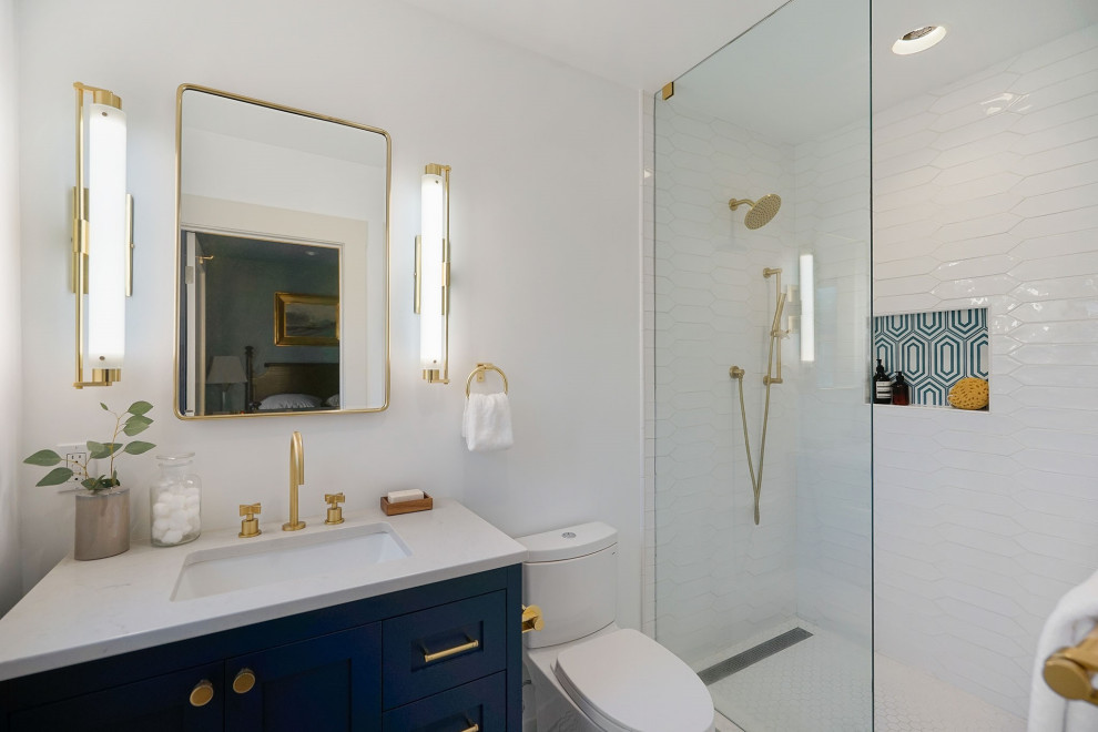Small transitional master bathroom in San Francisco with shaker cabinets, blue cabinets, an alcove shower, a two-piece toilet, white tile, ceramic tile, white walls, an undermount sink, engineered quartz benchtops, an open shower and grey benchtops.
